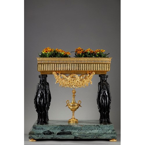 A planter with Empire style caryatids